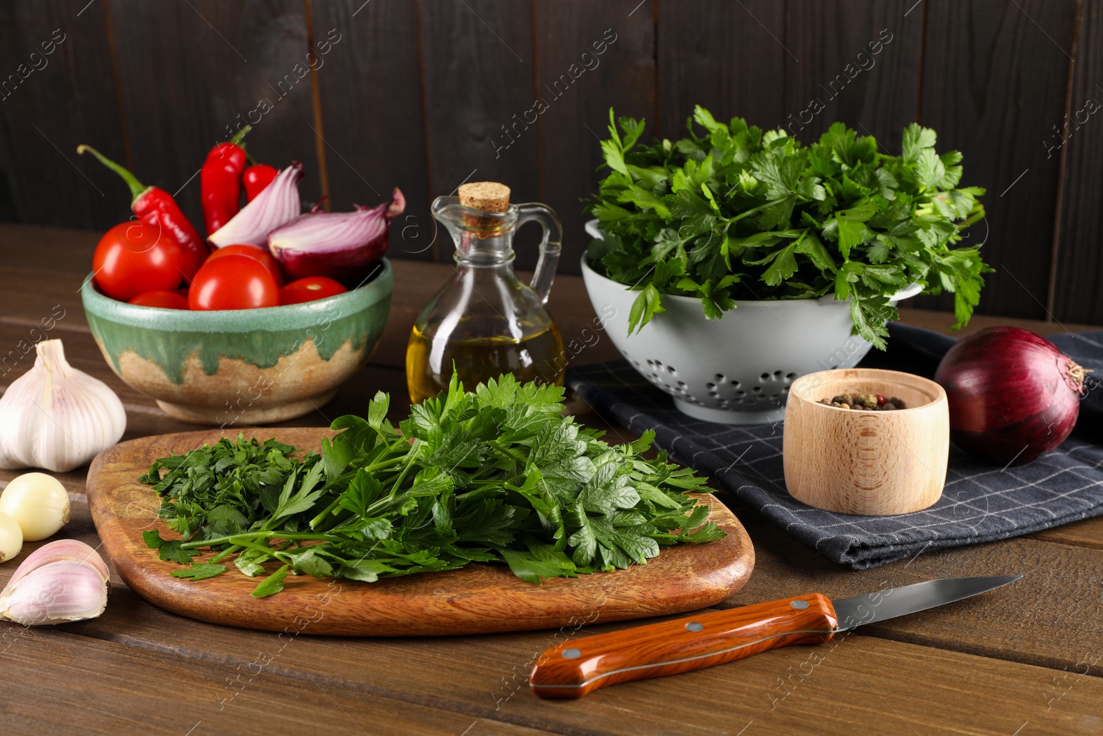 Photo of Fresh green parsley and different products on wooden table