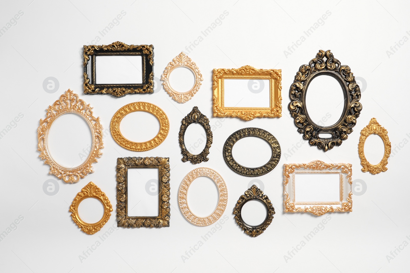 Photo of Empty vintage frames hanging on white wall