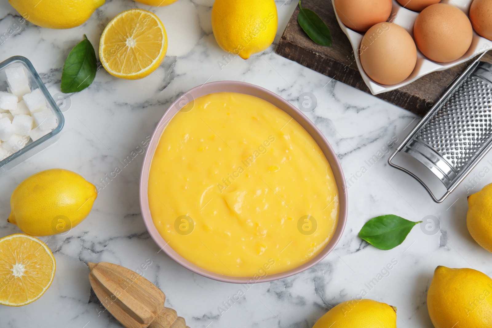 Photo of Delicious lemon curd and fresh fruits on white marble table, flat lay