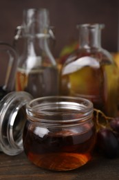 Different types of vinegar on wooden table