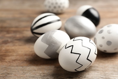 Photo of Painted Easter eggs on wooden background, closeup