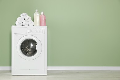 Empty laundry room with washing machine and detergents, space for text. Interior design