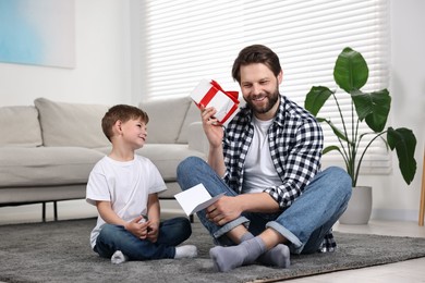 Happy Father's Day. Father guessing what inside gift box which giving him his son