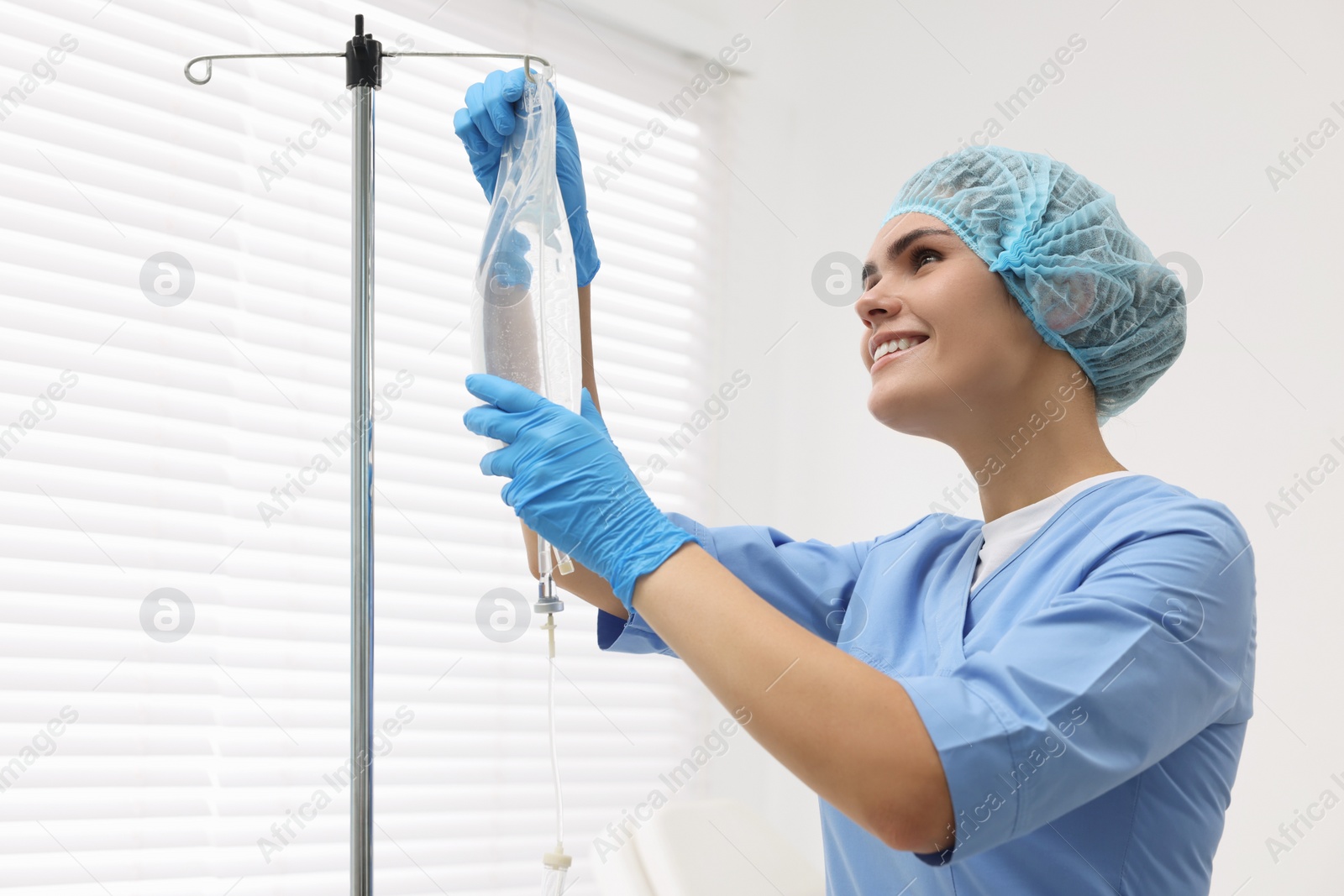 Photo of Nurse setting up IV drip in hospital