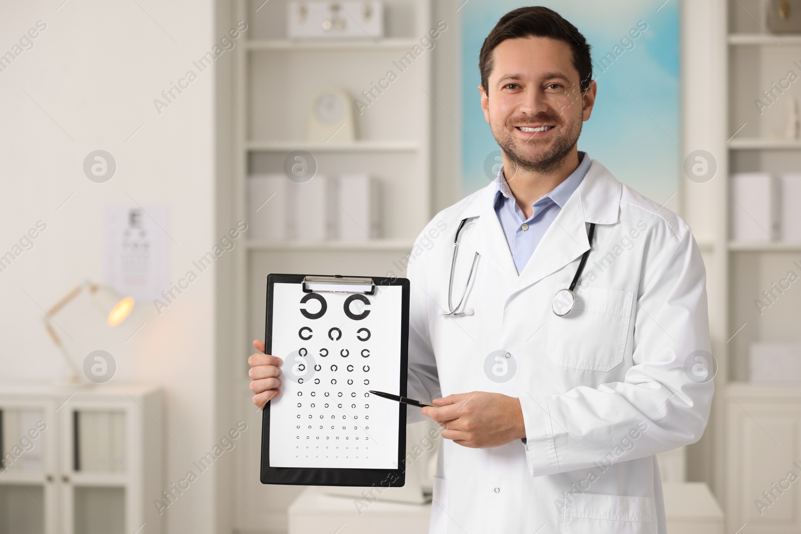 Photo of Ophthalmologist pointing at vision test chart in clinic, space for text