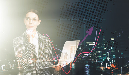 Double exposure of businesswoman with laptop and cityscape. Forex trading