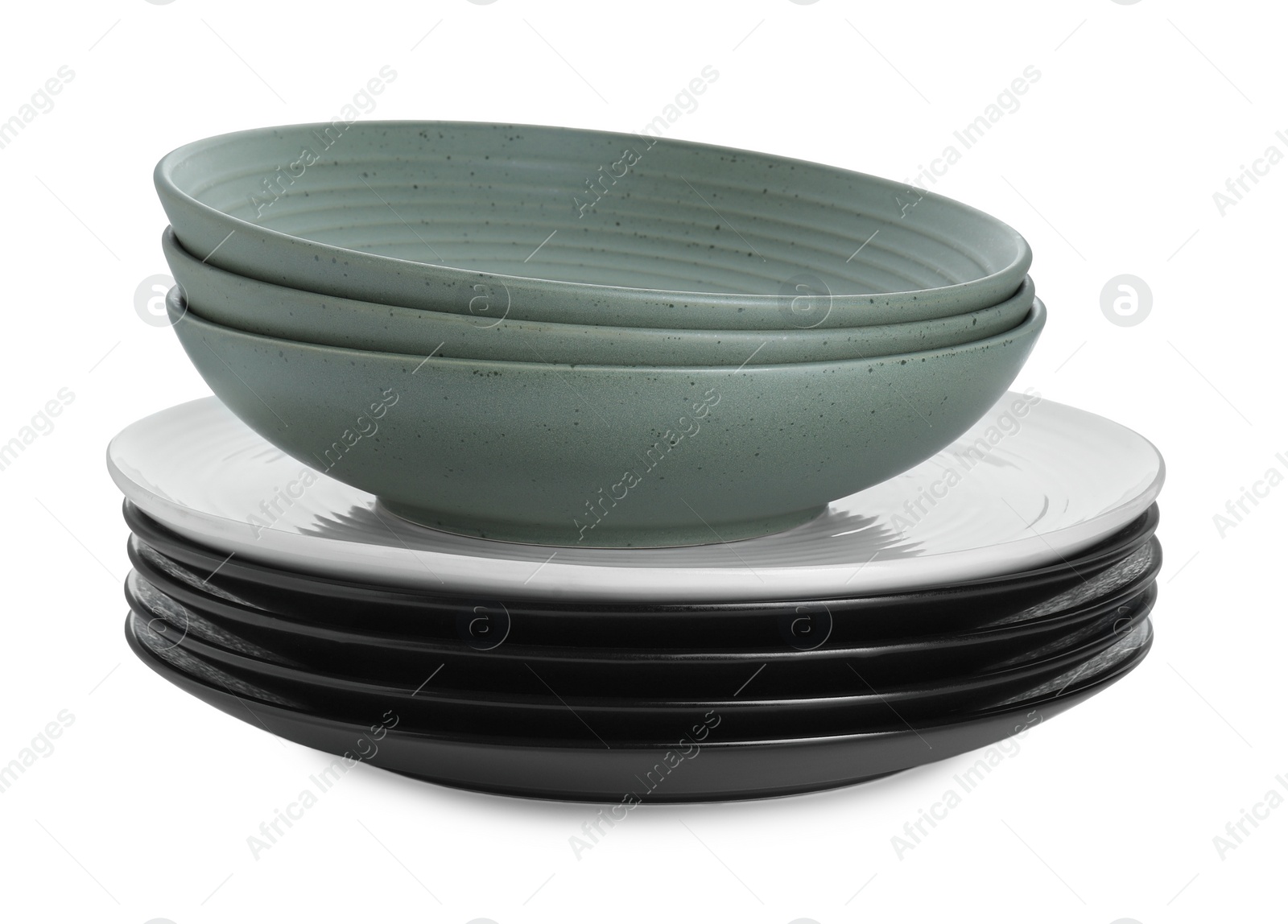 Photo of Stack of beautiful ceramic plates and bowls isolated on white