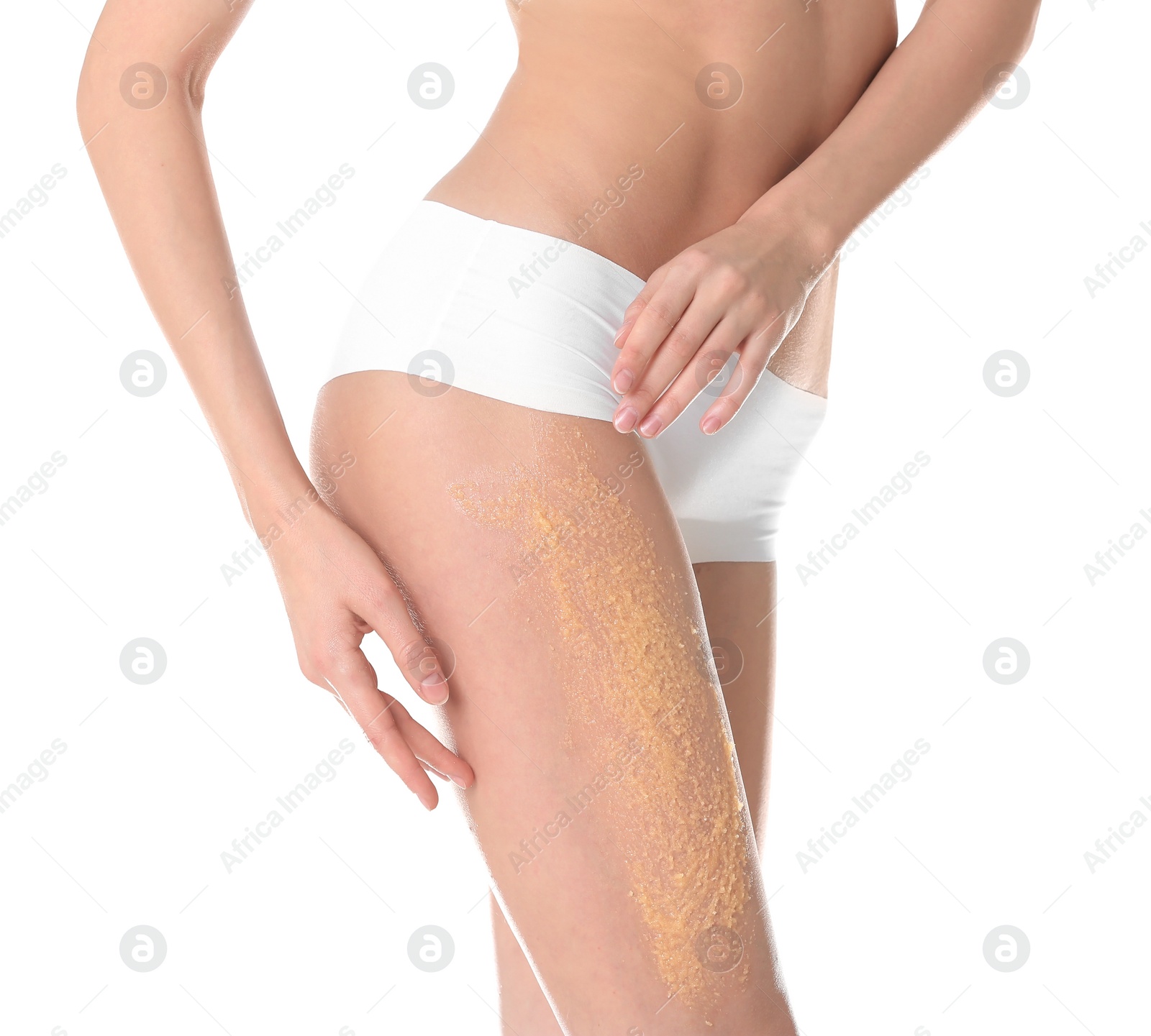 Photo of Young woman applying natural scrub on her body against white background