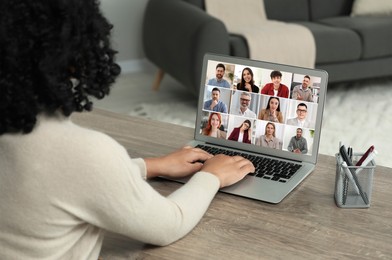 Image of Woman participating in webinar via laptop at table, closeup