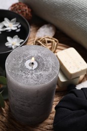 Photo of Beautiful composition with burning candle and spa products on table,closeup