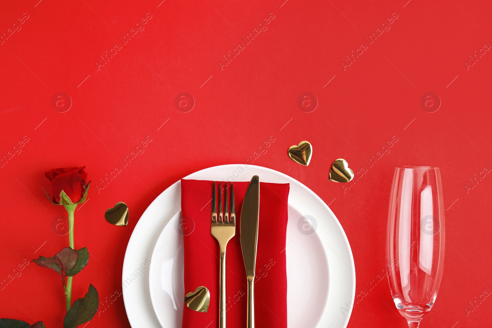 Photo of Romantic table setting on red background, flat lay with space for text. Valentine's day celebration