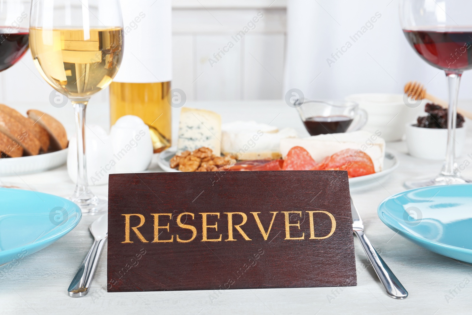 Photo of Table setting with RESERVED sign in restaurant