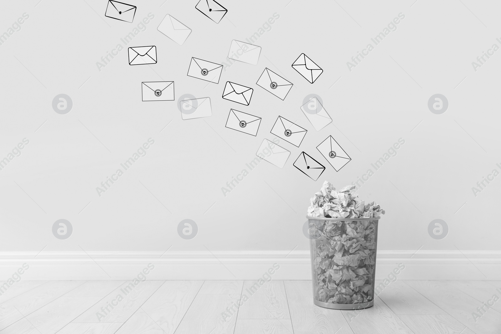 Image of Spam. Drawn envelopes falling into bin with crumpled paper near white wall