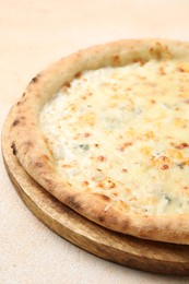 Photo of Delicious cheese pizza on beige textured table, closeup