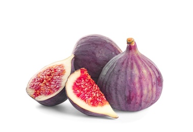 Whole and cut purple figs on white background