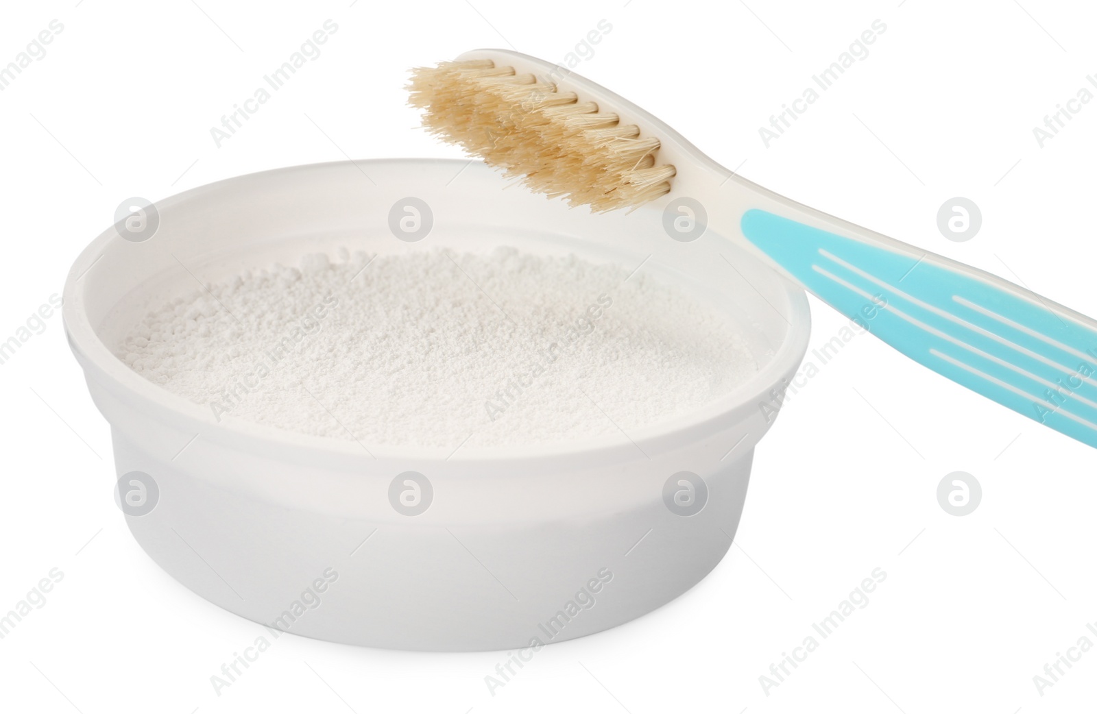 Photo of Bowl of tooth powder and brush on white background