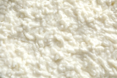 Photo of Delicious creamy rice pudding as background, top view