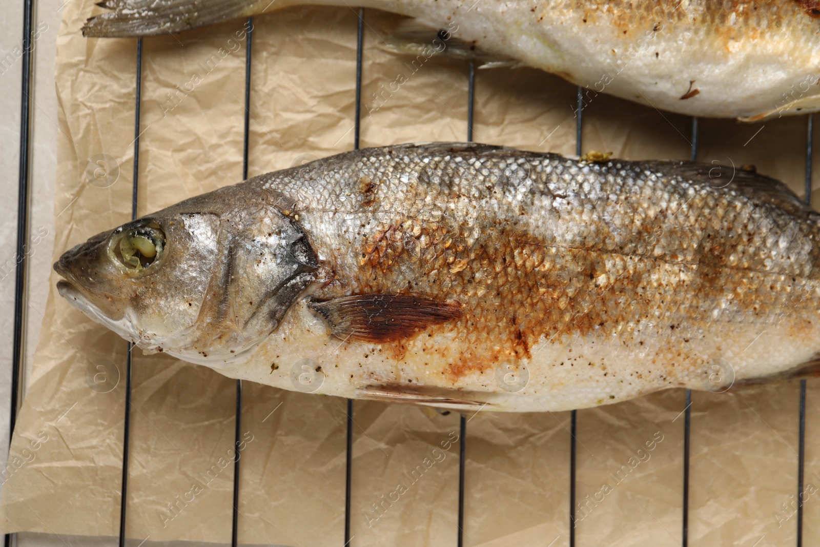 Photo of Baked fish on cooling rack, flat lay