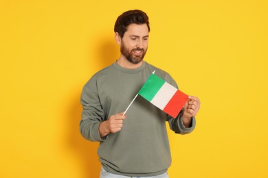 Photo of Man with flag of Italy on yellow background