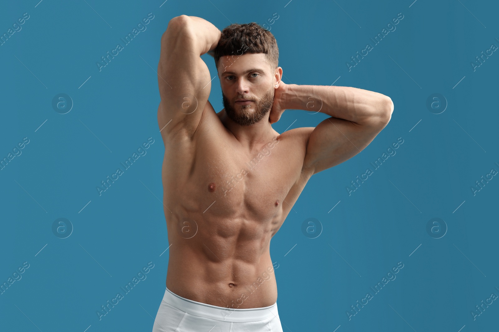 Photo of Handsome muscular man on light blue background. Sexy body