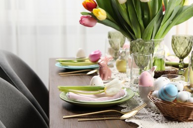 Festive table setting with beautiful flowers. Easter celebration