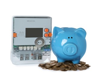 Photo of Electricity meter, piggy bank and coins on white background