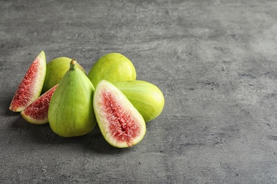 Fresh ripe figs on gray background. Space for text