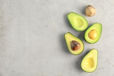 Photo of Flat lay composition with cut avocados on light background