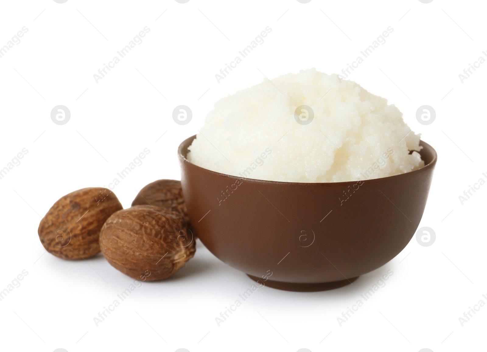 Photo of Shea butter in bowl and nuts isolated on white