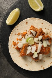 Delicious taco with vegetables, meat and lime on grey table, top view