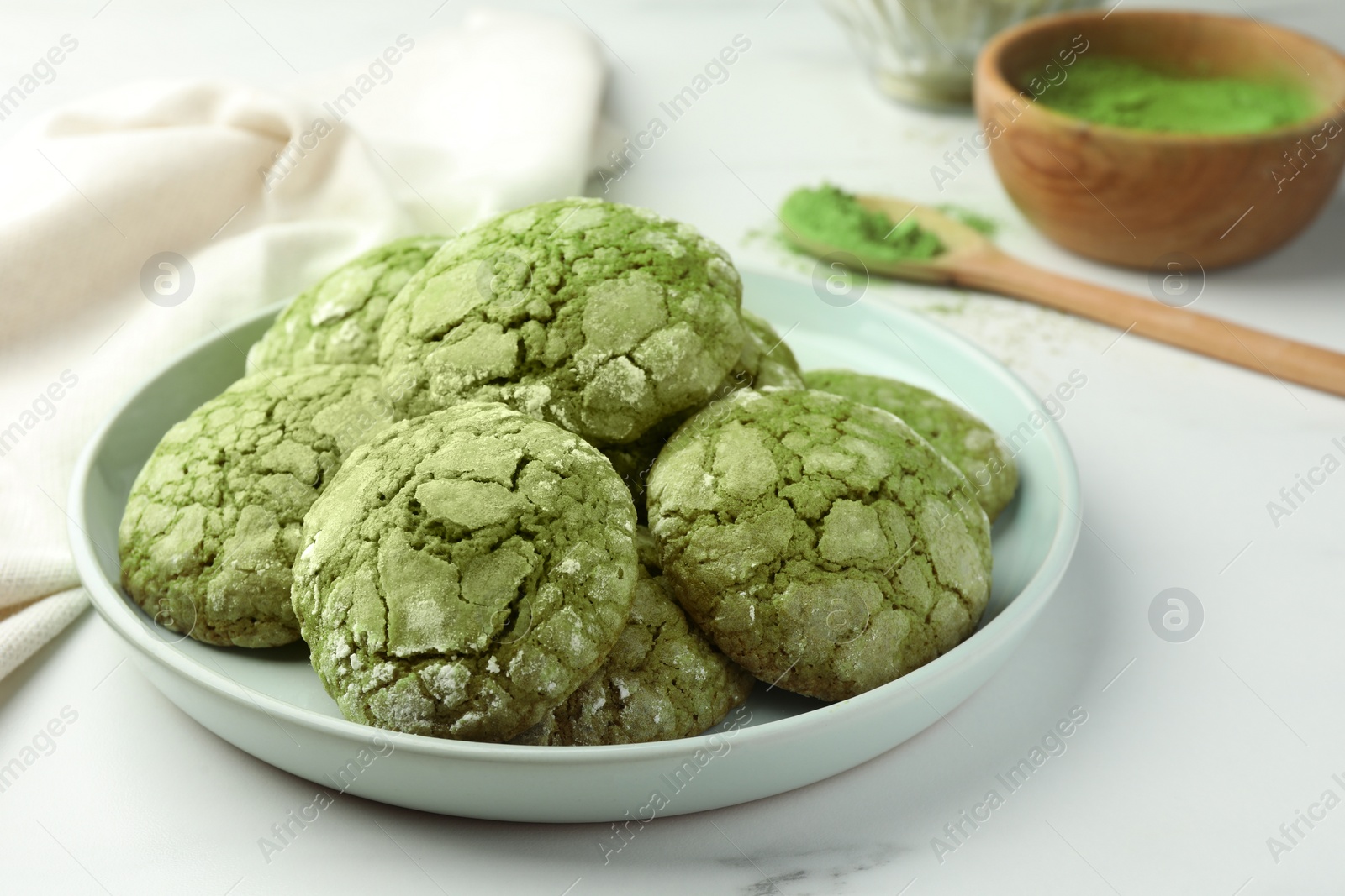 Photo of Plate with tasty matcha cookies on white table, closeup
