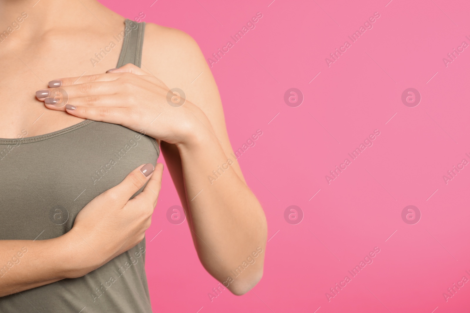 Photo of Woman checking her breast on color background, closeup. Space for text