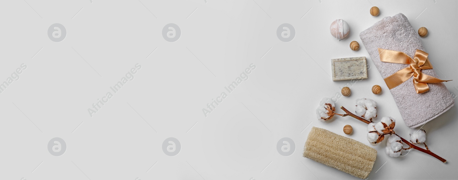 Image of Flat lay composition with towel and toiletries on light background, space for text. Banner design