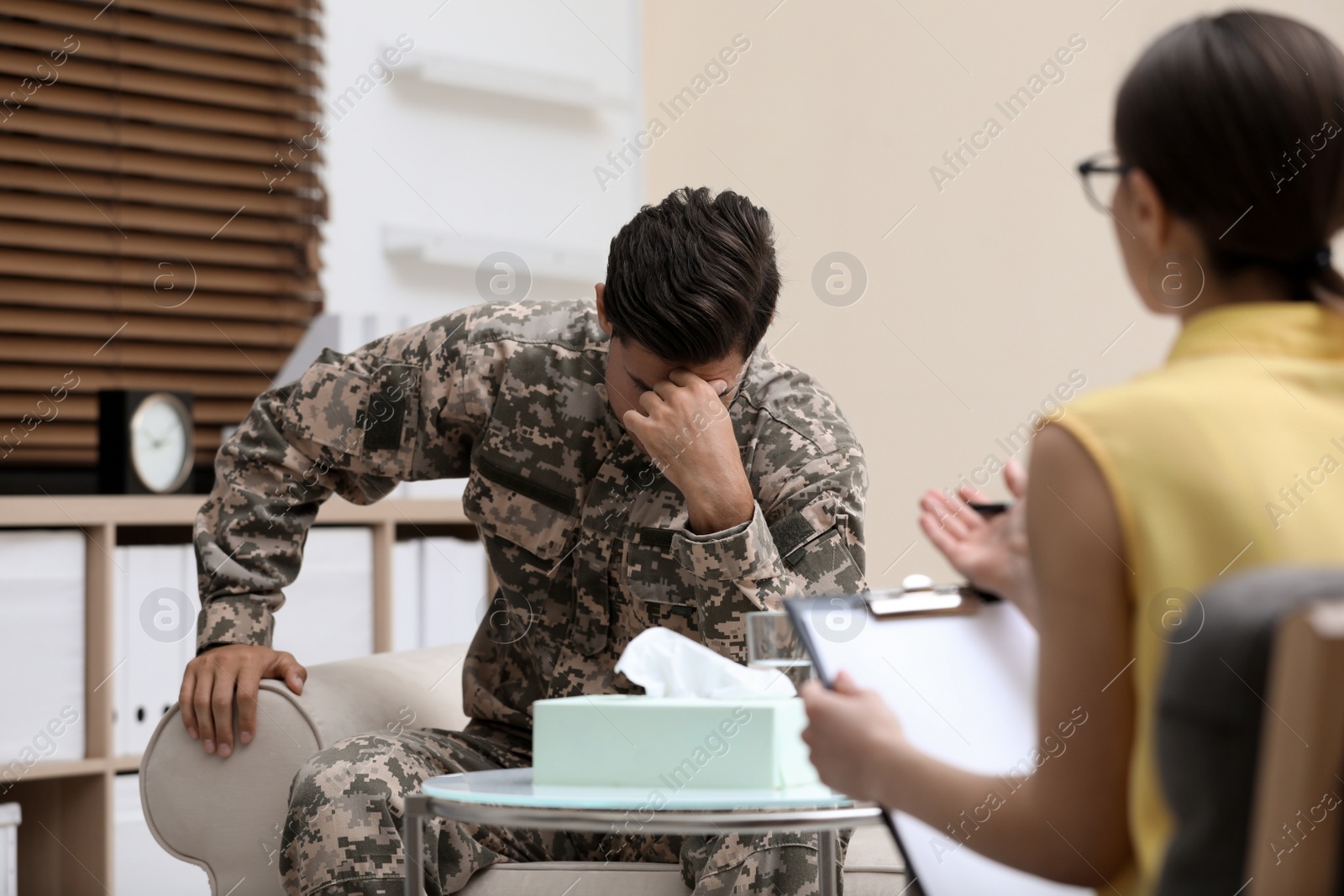 Photo of Psychotherapist working with male military officer in office