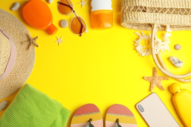 Photo of Flat lay composition with beach objects on yellow background. Space for text