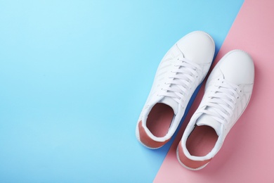 Photo of Pair of sneakers on color background, flat lay. Space for text