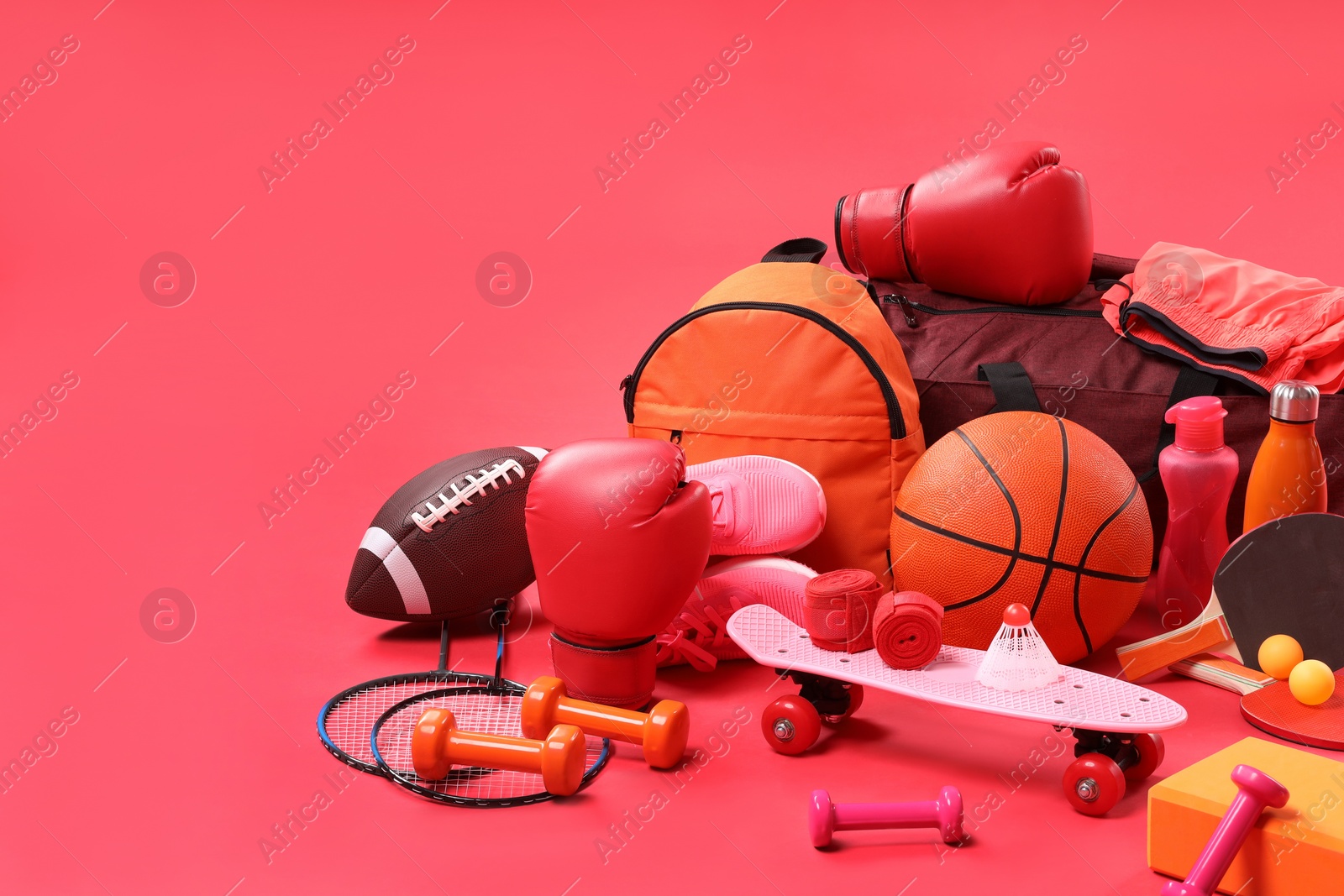 Photo of Many different sports equipment on red background, space for text