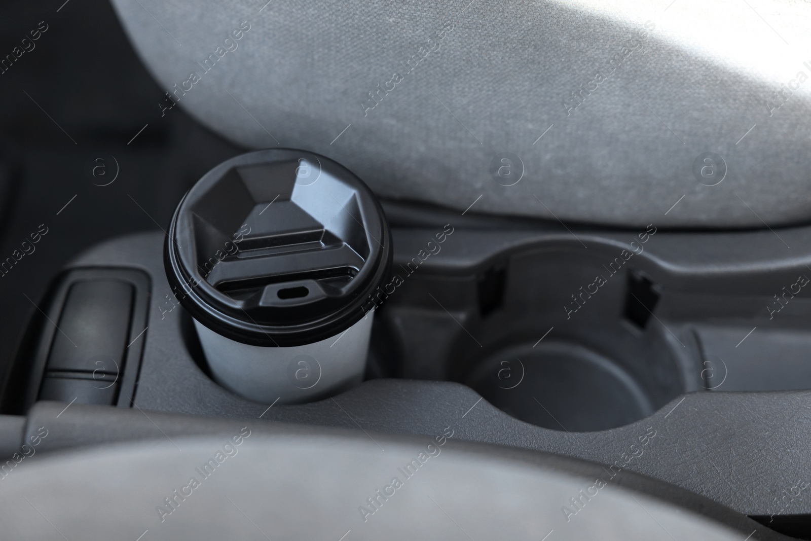 Photo of Coffee to go. Paper cup with tasty drink in holder inside of car, space for text