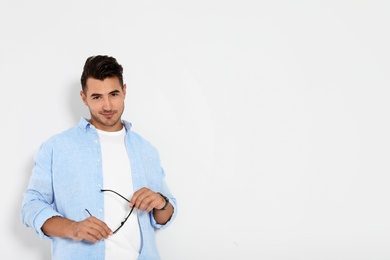 Portrait of handsome young man and space for text on white background