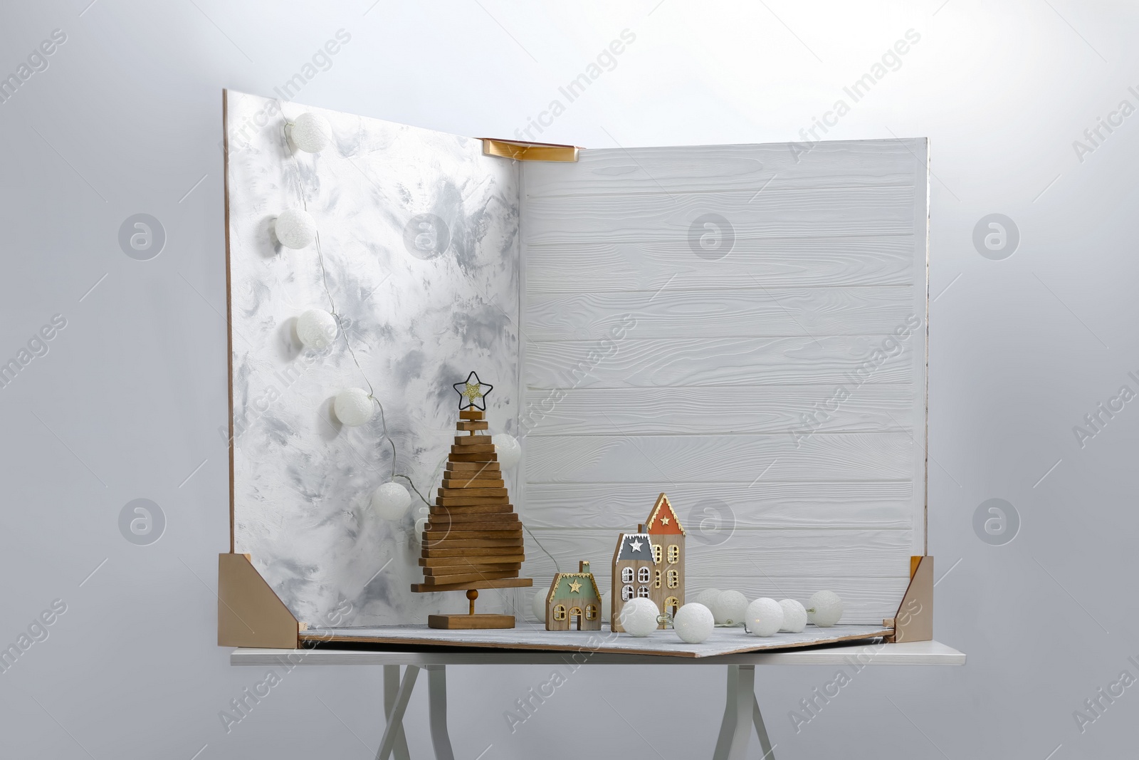 Photo of Christmas decor and double-sided backdrops on table in photo studio