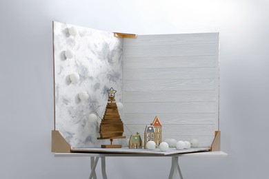 Photo of Christmas decor and double-sided backdrops on table in photo studio
