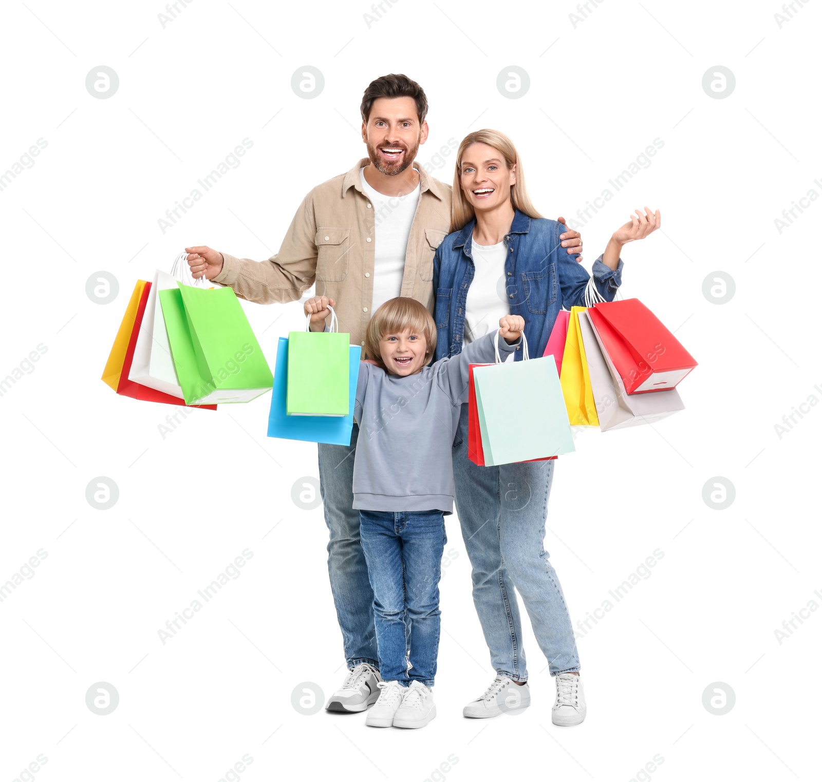 Photo of Family shopping. Happy parents and son with many colorful bags on white background