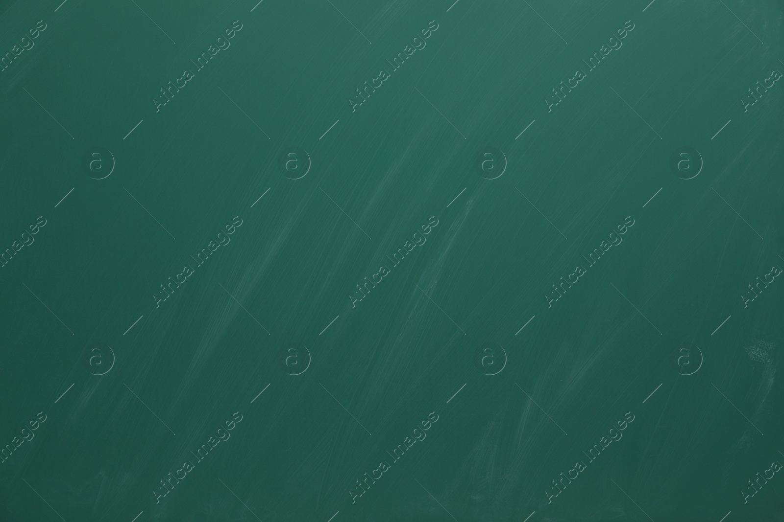 Photo of Dirty green chalkboard as background. School equipment