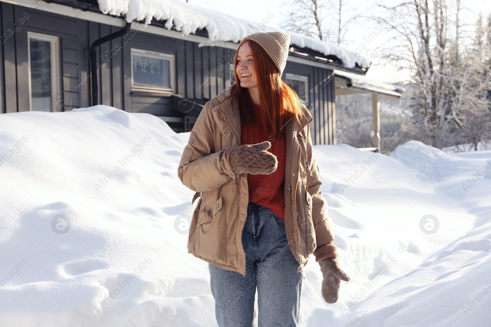 Photo of Portrait of beautiful young woman on snowy day outdoors. Winter vacation