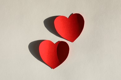 Photo of Paper hearts on light grey background, flat lay