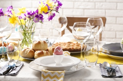 Photo of Festive Easter table setting with traditional meal at home