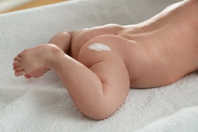 Photo of Cute little baby with cream on body, closeup