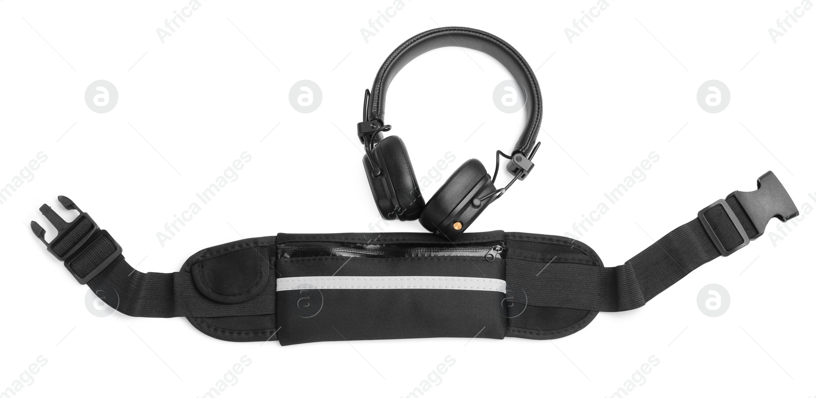 Photo of Stylish black waist bag and headphones isolated on white, top view