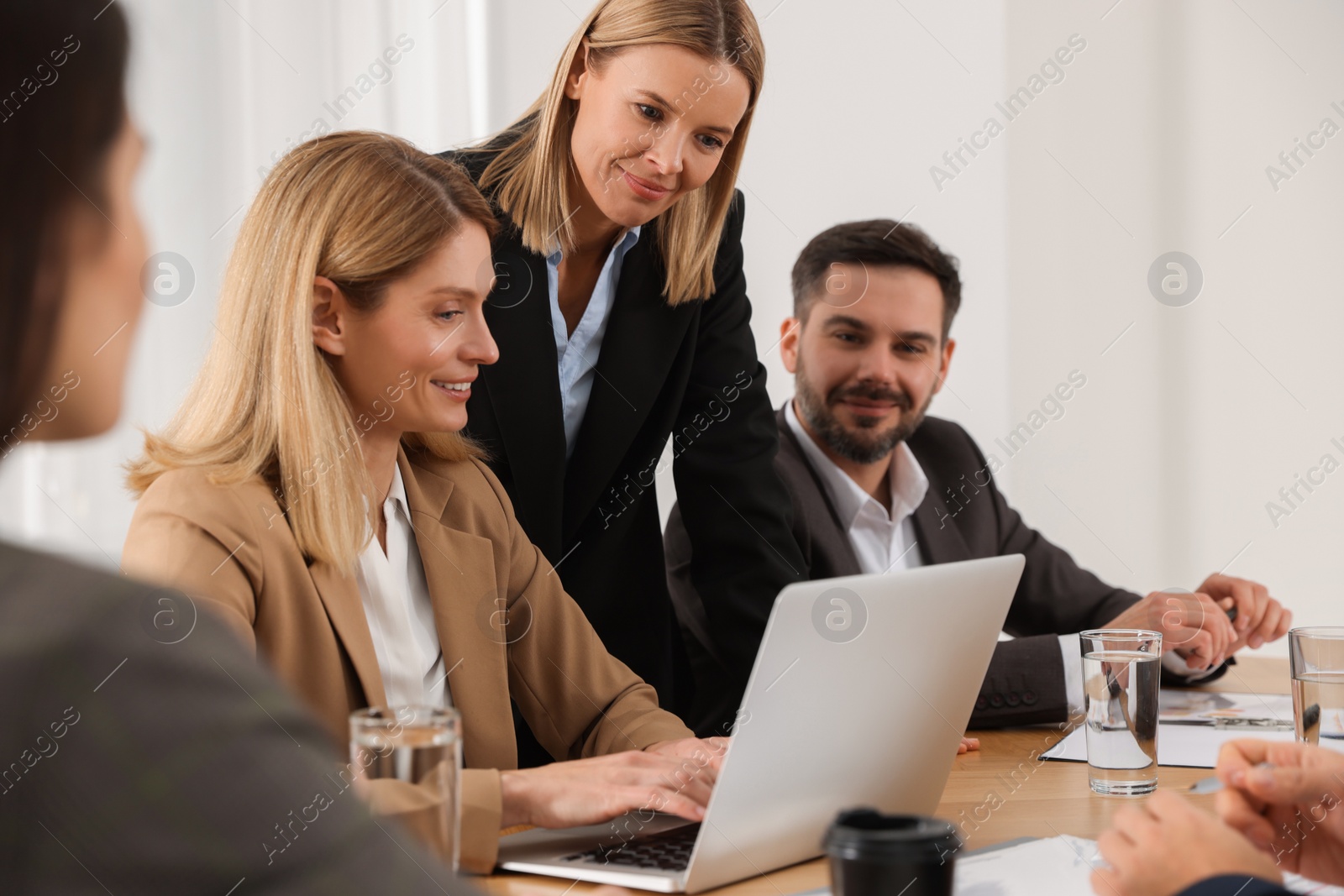 Photo of Businesswoman having meeting with her employees in office