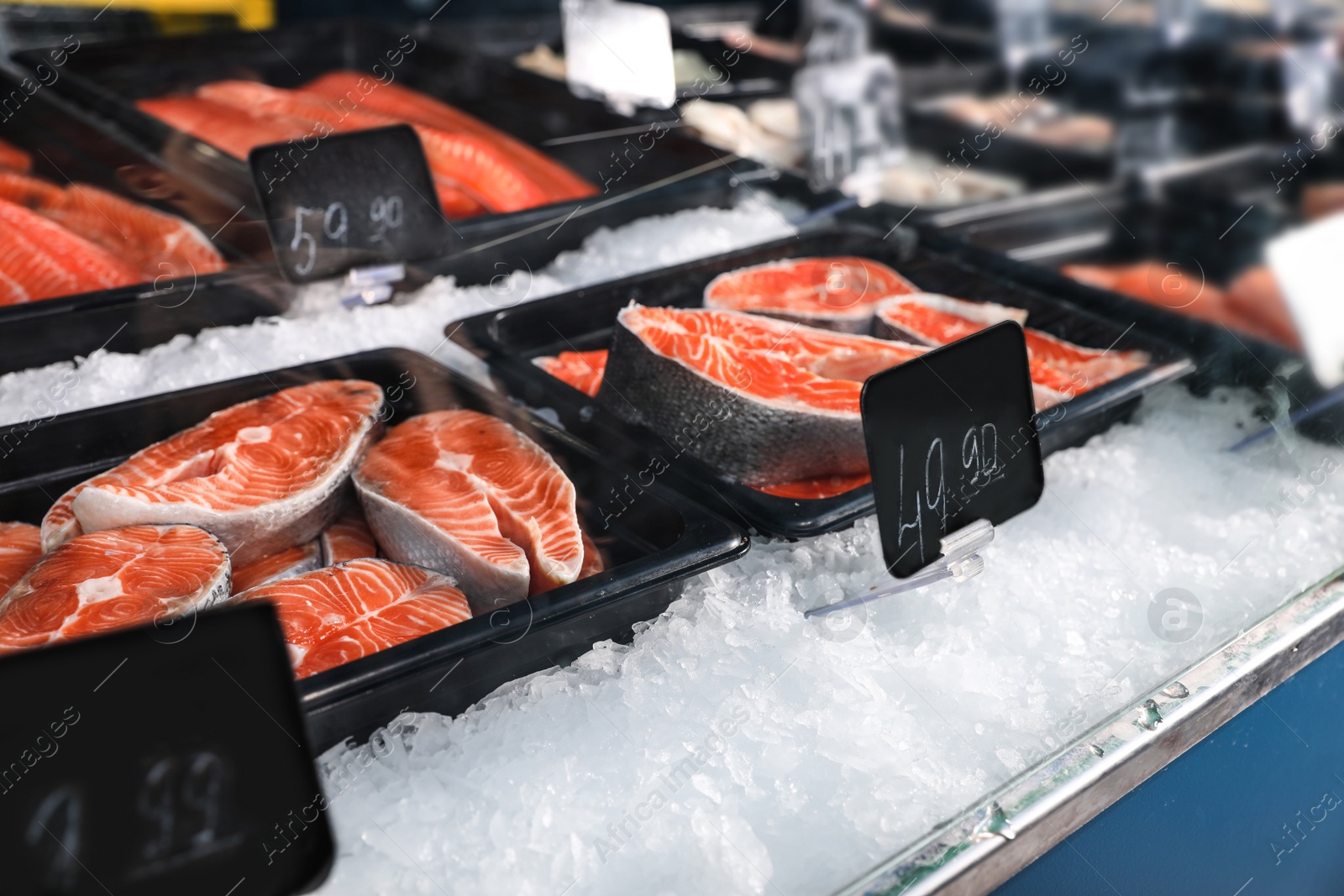 Photo of Steaks of fresh fish on ice in supermarket